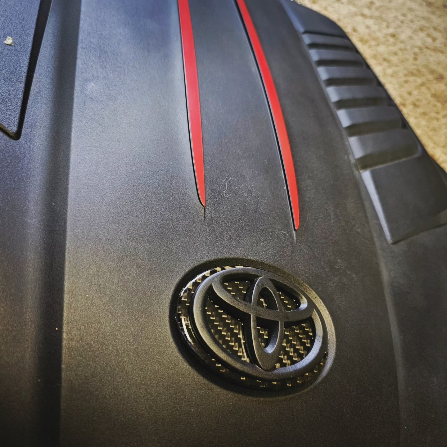 Carbon fiber engine badge